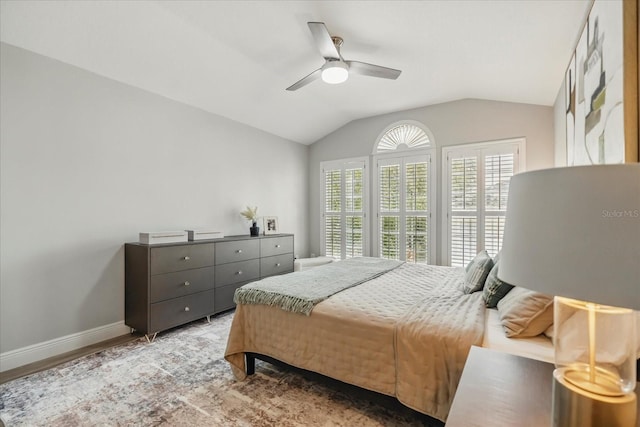 704 Honeysuckle Ave, Kissimmee, FL 34747 - bedroom with lofted ceiling, baseboards, wood finished floors, and a ceiling fan