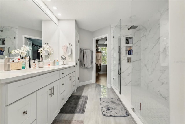 704 Honeysuckle Ave, Kissimmee, FL 34747 - full bath featuring a walk in closet, a marble finish shower, double vanity, and recessed lighting