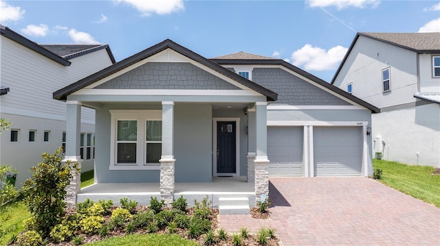 16489 Silver Brook Way, Winter Garden, FL 34787 - craftsman-style home featuring a porch, an attached garage, stucco siding, and decorative driveway