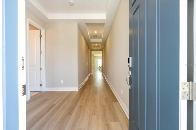 16489 Silver Brook Way, Winter Garden, FL 34787 - hall with a tray ceiling, light wood-type flooring, and baseboards