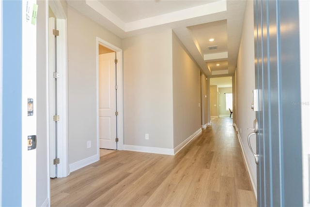16489 Silver Brook Way, Winter Garden, FL 34787 - corridor with a raised ceiling, light wood finished floors, and baseboards