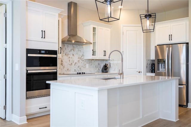 16489 Silver Brook Way, Winter Garden, FL 34787 - kitchen with wall chimney exhaust hood, stainless steel appliances, a sink, backsplash, and light wood finished floors