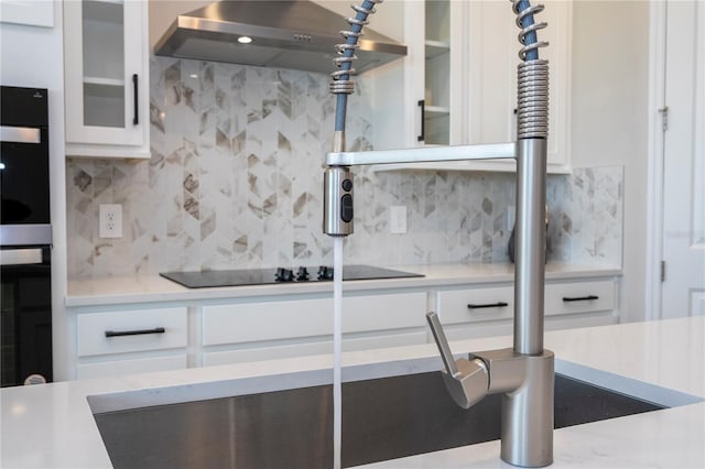 16489 Silver Brook Way, Winter Garden, FL 34787 - kitchen with decorative backsplash, light countertops, white cabinets, range hood, and glass insert cabinets