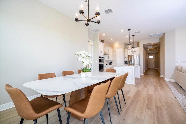 16489 Silver Brook Way, Winter Garden, FL 34787 - dining room featuring a chandelier, baseboards, light wood-type flooring, and recessed lighting
