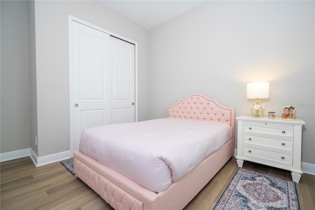 16489 Silver Brook Way, Winter Garden, FL 34787 - bedroom featuring a closet, baseboards, and light wood-style floors