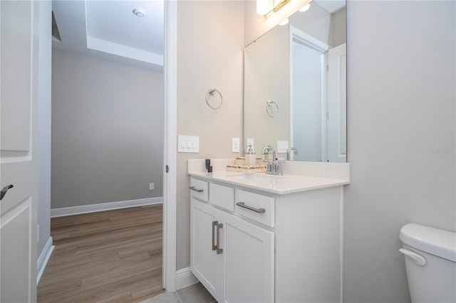 16489 Silver Brook Way, Winter Garden, FL 34787 - bathroom featuring vanity, toilet, wood finished floors, and baseboards