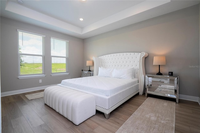 16489 Silver Brook Way, Winter Garden, FL 34787 - bedroom featuring baseboards, a raised ceiling, wood finished floors, and recessed lighting