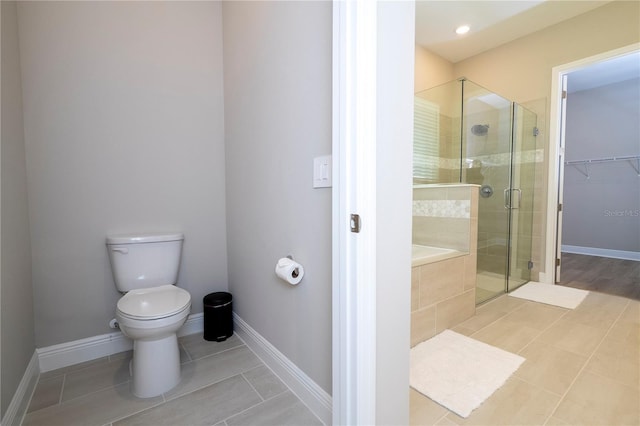 16489 Silver Brook Way, Winter Garden, FL 34787 - bathroom featuring tile patterned flooring, a shower stall, toilet, and baseboards