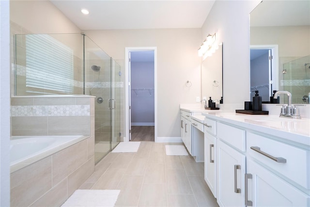 16489 Silver Brook Way, Winter Garden, FL 34787 - full bath with double vanity, a shower stall, a garden tub, tile patterned flooring, and baseboards