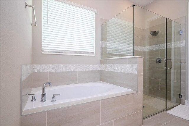 16489 Silver Brook Way, Winter Garden, FL 34787 - full bathroom with a shower stall, a garden tub, and tile patterned flooring