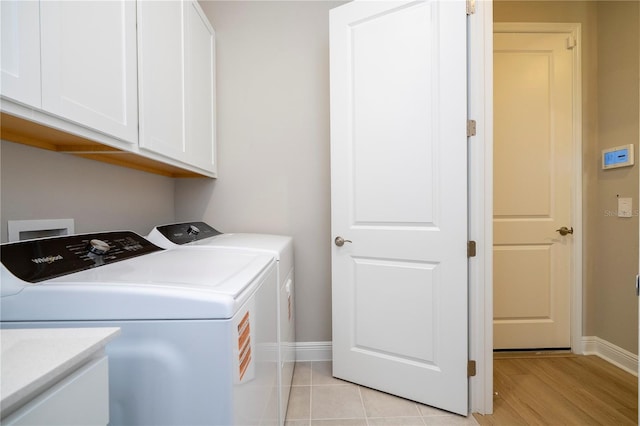 16489 Silver Brook Way, Winter Garden, FL 34787 - laundry area featuring cabinet space, washing machine and dryer, baseboards, and light wood-style flooring