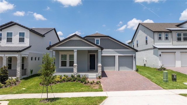 16489 Silver Brook Way, Winter Garden, FL 34787 - craftsman house with covered porch, decorative driveway, a front lawn, a garage, and stucco siding
