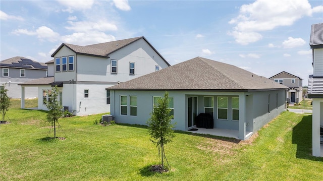 16489 Silver Brook Way, Winter Garden, FL 34787 - back of house featuring stucco siding, a shingled roof, a lawn, and a patio area