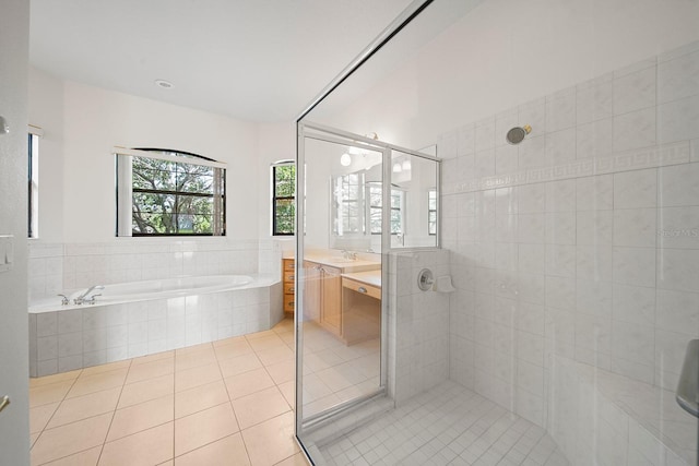 453 Sorrento Rd, Kissimmee, FL 34759 - bathroom with tile patterned floors, vanity, a garden tub, and a tile shower