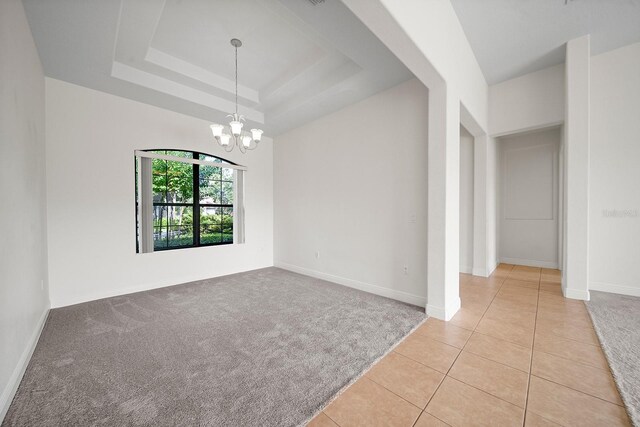 453 Sorrento Rd, Kissimmee, FL 34759 - unfurnished room with a chandelier, light tile patterned flooring, baseboards, and light carpet