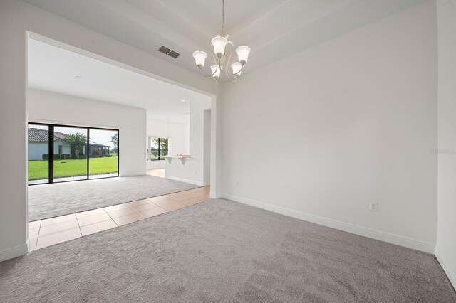 453 Sorrento Rd, Kissimmee, FL 34759 - tiled spare room with a chandelier, carpet, and baseboards