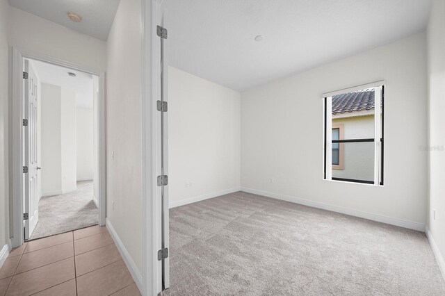 453 Sorrento Rd, Kissimmee, FL 34759 - spare room with carpet, a smoke detector, and baseboards