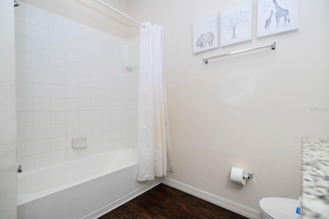 3229 Cupid Pl, Kissimmee, FL 34747 - full bath with baseboards, shower / tub combo, toilet, and wood finished floors