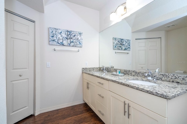 3229 Cupid Pl, Kissimmee, FL 34747 - full bath featuring double vanity, baseboards, wood finished floors, and toilet