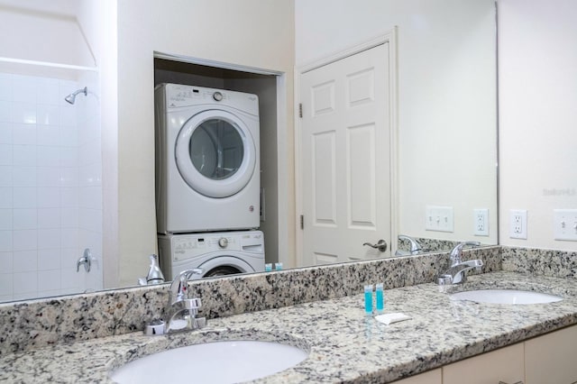 3229 Cupid Pl, Kissimmee, FL 34747 - bathroom with stacked washer / dryer, double vanity, and tiled shower