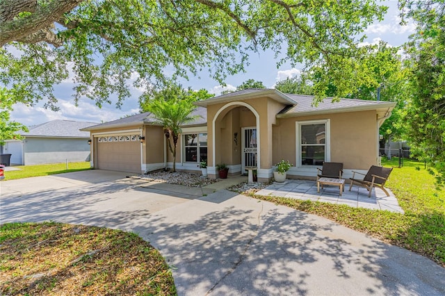 46 Frenora Ln, Palm Coast, FL 32137 - ranch-style house featuring stucco siding, a garage, and concrete driveway