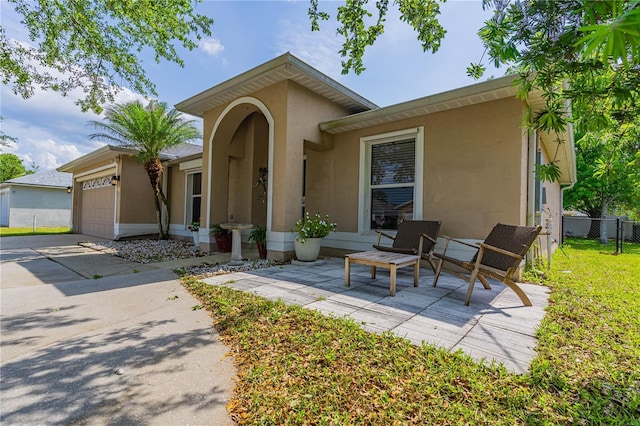 46 Frenora Ln, Palm Coast, FL 32137 - view of front of home with stucco siding and an attached garage