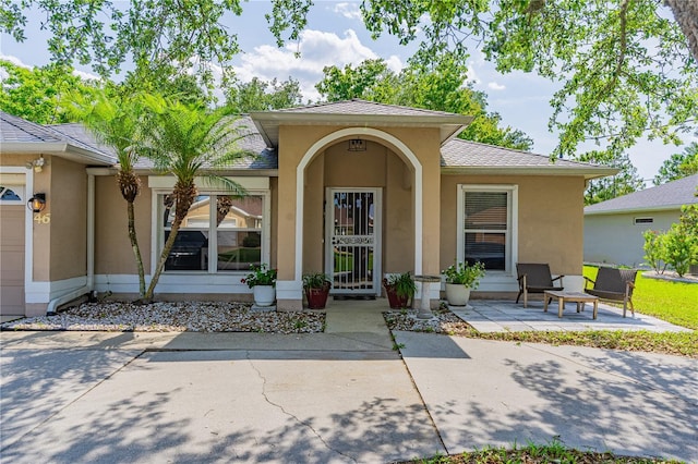 46 Frenora Ln, Palm Coast, FL 32137 - property entrance featuring stucco siding and a patio area