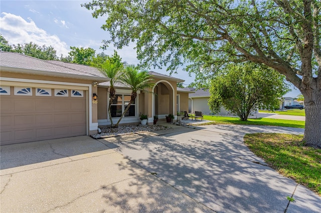 46 Frenora Ln, Palm Coast, FL 32137 - view of front facade featuring driveway, a garage, and stucco siding