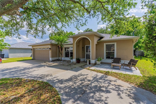 46 Frenora Ln, Palm Coast, FL 32137 - single story home featuring stucco siding, an attached garage, and driveway