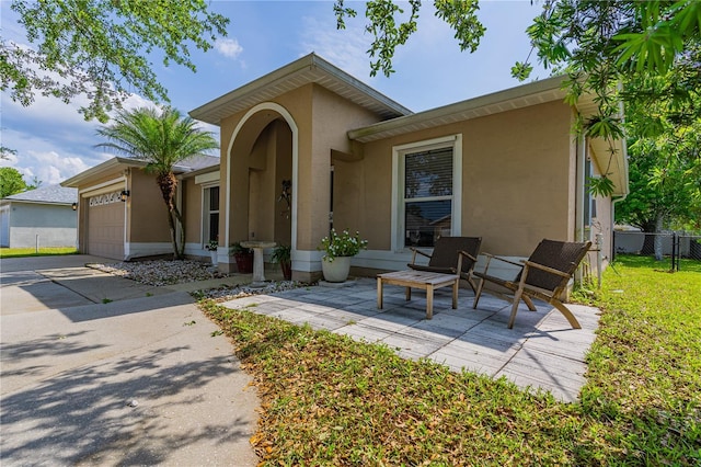 46 Frenora Ln, Palm Coast, FL 32137 - view of front facade featuring stucco siding and a garage