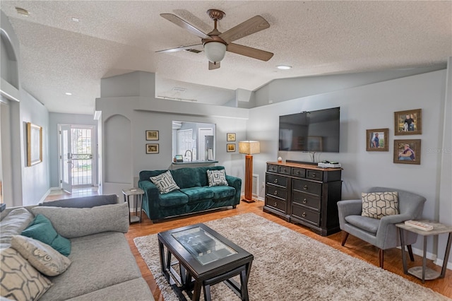 46 Frenora Ln, Palm Coast, FL 32137 - living area featuring a textured ceiling, a ceiling fan, vaulted ceiling, light wood-type flooring, and baseboards