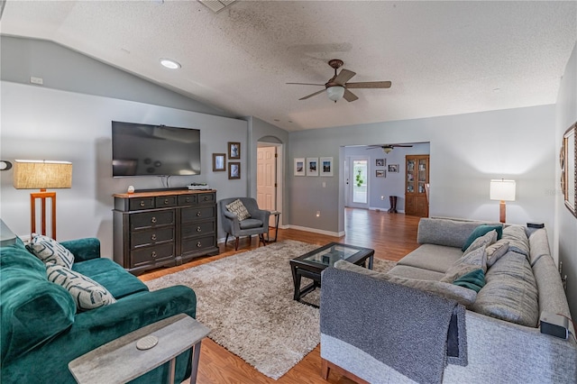 46 Frenora Ln, Palm Coast, FL 32137 - living room with ceiling fan, lofted ceiling, wood finished floors, arched walkways, and a textured ceiling