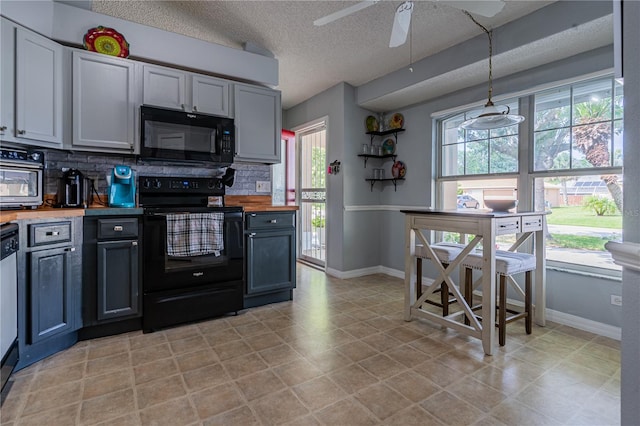 46 Frenora Ln, Palm Coast, FL 32137 - kitchen featuring black appliances, tasteful backsplash, baseboards, butcher block countertops, and a textured ceiling