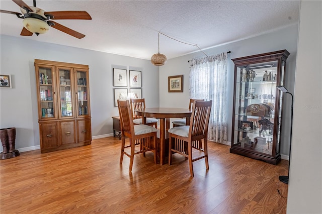 46 Frenora Ln, Palm Coast, FL 32137 - dining area with ceiling fan, light wood finished floors, a textured ceiling, and baseboards