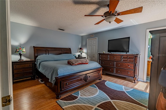 46 Frenora Ln, Palm Coast, FL 32137 - bedroom featuring wood finished floors, a textured ceiling, and a ceiling fan