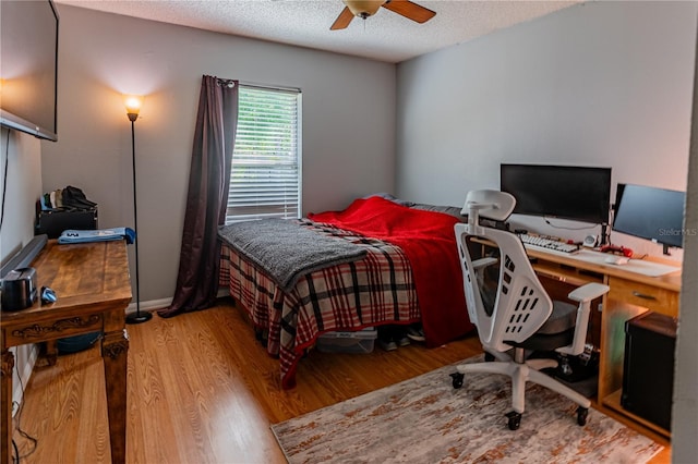 46 Frenora Ln, Palm Coast, FL 32137 - bedroom with light wood-type flooring, a desk, a textured ceiling, and ceiling fan