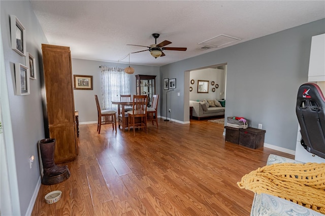 46 Frenora Ln, Palm Coast, FL 32137 - dining room with ceiling fan, light wood finished floors, a textured ceiling, and baseboards