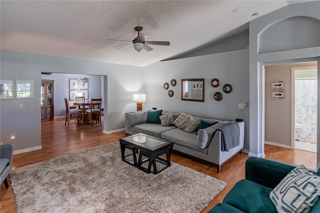 46 Frenora Ln, Palm Coast, FL 32137 - living room with lofted ceiling, a ceiling fan, wood finished floors, a textured ceiling, and baseboards