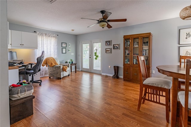 46 Frenora Ln, Palm Coast, FL 32137 - dining space featuring a ceiling fan, light wood-style floors, a desk, a textured ceiling, and french doors