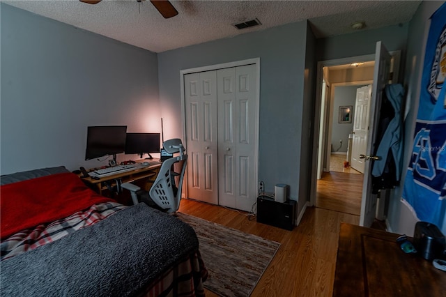 46 Frenora Ln, Palm Coast, FL 32137 - bedroom featuring wood finished floors, a textured ceiling, a closet, ceiling fan, and an office area