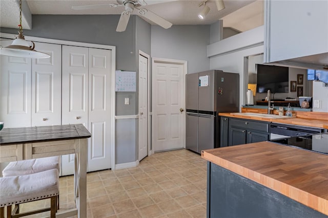 46 Frenora Ln, Palm Coast, FL 32137 - kitchen with butcher block counters, freestanding refrigerator, ceiling fan, a sink, and lofted ceiling