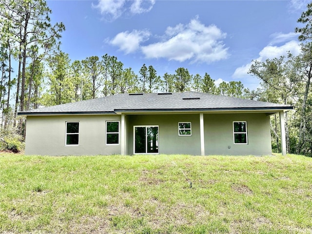 9335 N Fairy Lilly Dr, Citrus Springs, FL 34433 - rear view of house featuring stucco siding, a yard, and a shingled roof