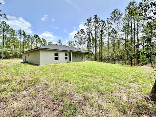 9335 N Fairy Lilly Dr, Citrus Springs, FL 34433 - rear view of property featuring stucco siding and a lawn