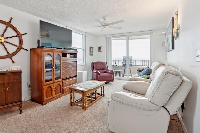 3360 Ocean Shore Blvd Unit 4050, Ormond Beach, FL 32176 - living room with ceiling fan, a textured ceiling, and carpet floors