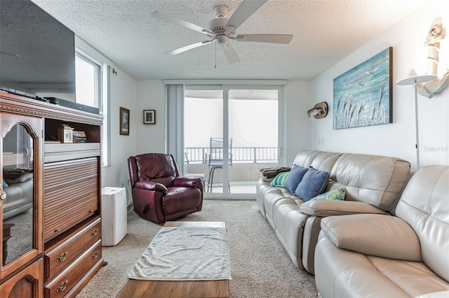 3360 Ocean Shore Blvd Unit 4050, Ormond Beach, FL 32176 - living room featuring a textured ceiling, ceiling fan, and light colored carpet