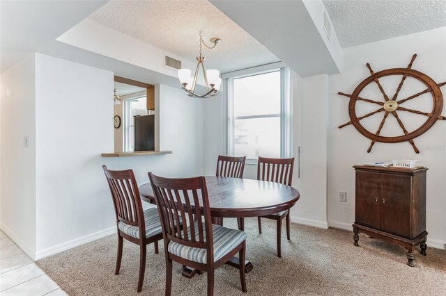 3360 Ocean Shore Blvd Unit 4050, Ormond Beach, FL 32176 - dining room featuring a textured ceiling, baseboards, a chandelier, and carpet floors