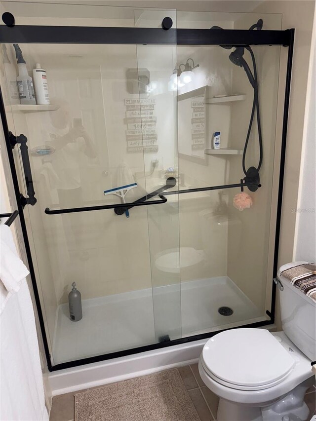 3360 Ocean Shore Blvd Unit 4050, Ormond Beach, FL 32176 - full bathroom with tile patterned floors, a shower stall, and toilet