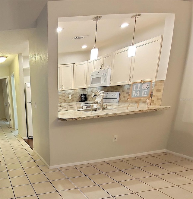 1108 Northlake Dr Unit 1108, Sanford, FL 32773 - kitchen featuring white appliances, decorative backsplash, white cabinetry, and light countertops