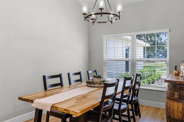 5478 NW 153rd Ct, Morriston, FL 32668 - dining room featuring baseboards, wood finished floors, a chandelier, and healthy amount of natural light