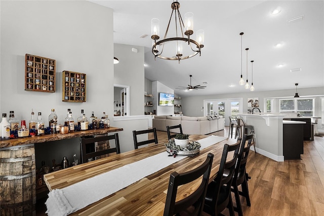 5478 NW 153rd Ct, Morriston, FL 32668 - dining space with wood finished floors, a bar, a chandelier, ceiling fan, and recessed lighting